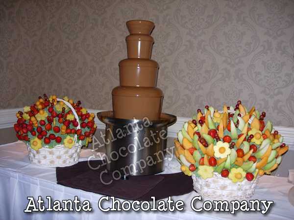 34 INCH CHOCOLATE FOUNTAIN AT WEDDING IN ATLANTA GEORGIA WITH BELGIAN MILK CHOCOLATE ACCOMPANIED BY BEAUTIFUL EDIBLE FRUIT BASKETS